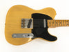 Vintage Fender Telecaster electric guitar with butterscotch blonde finish and black pickguard, showing worn and aged details on body and maple fretboard.