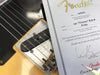 Close-up of Fender 1951 Nocaster Relic guitar pickup and partial Fender Custom Shop certificate of authenticity dated 04/24/12.