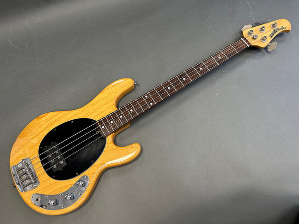 Natural finish Music Man StingRay electric bass guitar with black pickguard and rosewood fretboard on gray background