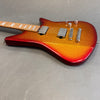 Electric guitar with metallic red to orange burst finish, maple fretboard, dual humbucker pickups, and chrome hardware on gray background