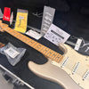 Fender electric guitar with maple neck and pearl finish in black hardshell case including Fender owner's registration, tags, polishing cloth, and plastic packaging with key accessory from Coffee House Guitars.