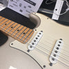Close-up of electric guitar body and maple fretboard with single-coil pickups and cream pickguard on a silver finish guitar at Coffee House Guitars