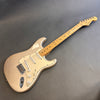 Fender Stratocaster electric guitar with maple neck and vintage white body on gray background