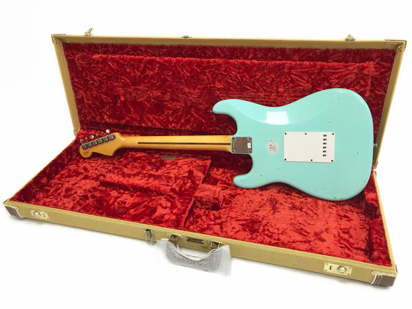 Vintage seafoam green electric guitar with maple neck in open tweed hard case lined with red plush interior