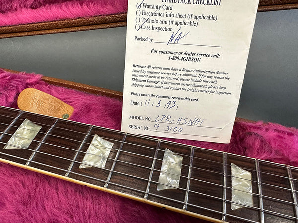 Close-up of guitar fretboard with pearl inlays in a pink plush-lined guitar case, accompanied by a final pack checklist and warranty card for a PRS guitar model LPR-HSNH1 dated 11/13/93 with serial number 93100.