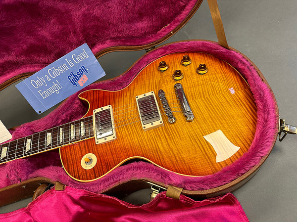 Gibson Les Paul electric guitar with flame maple top in sunburst finish inside pink plush-lined hardshell case with Gibson promotional card
