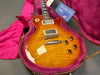 Gibson Les Paul electric guitar with sunburst finish in open hard case with plush pink interior and Gibson branded booklet