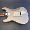 Back view of Fender Custom electric guitar with light metallic finish and maple neck on gray background