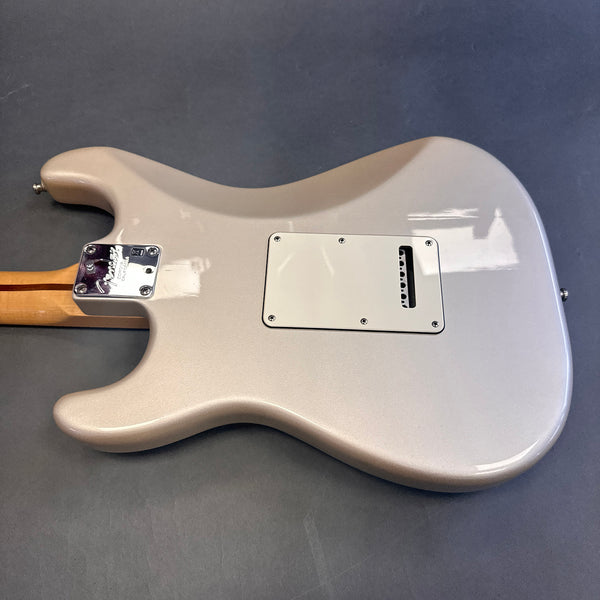 Back view of Fender Custom electric guitar with light metallic finish and maple neck on gray background