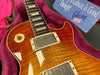 Close-up of Gibson Les Paul electric guitar with sunburst finish in plush pink-lined guitar case