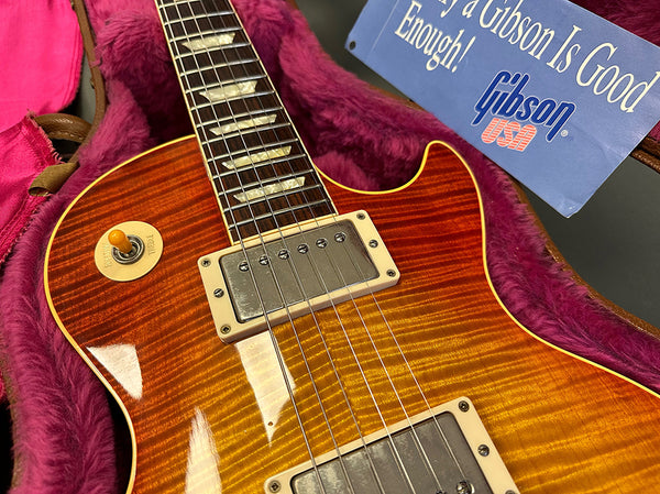 Close-up of Gibson Les Paul electric guitar with sunburst finish in plush pink-lined guitar case