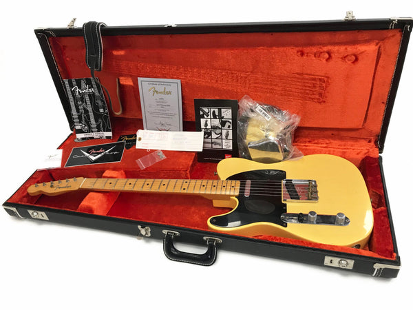 Fender Telecaster electric guitar in vintage blonde finish with black pickguard, maple neck and fingerboard, displayed inside black hard case with red plush interior, including Fender owner's manual, certificate of authenticity, strap, and additional accessories.