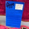 Gibson USA warranty certificate for Les Paul '57 Black Beauty guitar with serial number 77061 inside pink velvet guitar case