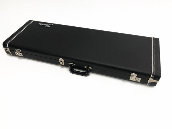 Black rectangular hard shell guitar case with silver latches and handle, white stitching detail, and Fender logo on top panel displayed on white background.