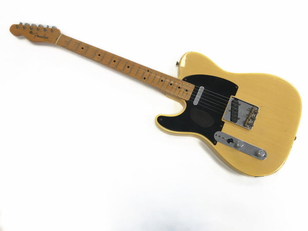 Vintage Fender Telecaster electric guitar with blonde finish and black pickguard, maple neck and fretboard, six strings, and chrome hardware on white background