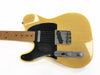 Vintage yellow electric guitar with black pickguard and maple fretboard, close-up on body and controls