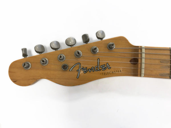 Close-up of vintage Fender Telecaster guitar headstock with six tuning pegs and strings on white background