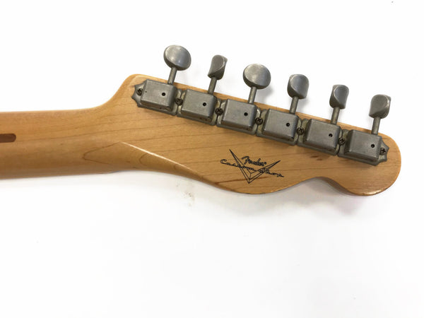 Vintage Fender Custom Shop guitar neck with six tuners and Fender Custom Shop logo on natural wood headstock against white background