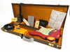Fender Custom Shop electric guitar in red finish with vintage wear, displayed inside orange plush-lined hard case with Fender certificate of authenticity, guitar strap, tremolo arm, instrument cable, and documentation
