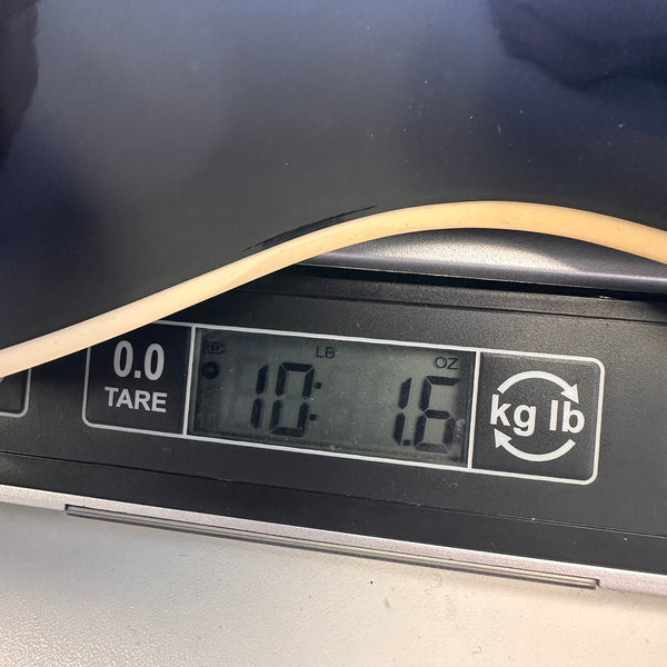 Close-up of guitar body edge on digital scale showing weight 10 pounds 1.6 ounces for Coffee House Guitars product listing.