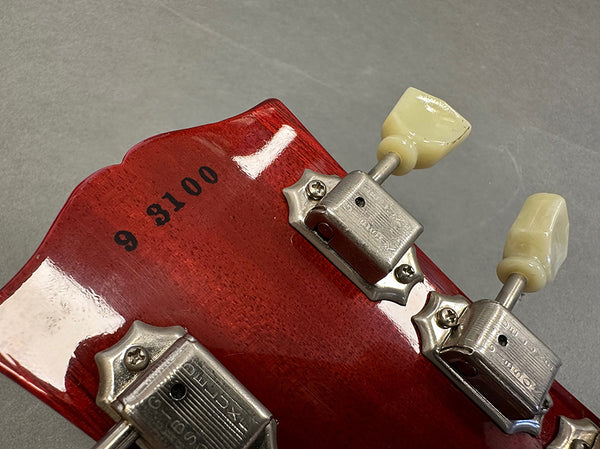 Close-up of Guitar Headstock Serial Number 9 3100 with Vintage Kluson Deluxe Tuning Pegs on Glossy Red Wood Finish
