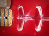 Close-up of red electric guitar body cavity with wood neck heel and embossed "YS" marking, showing neck joint and fretboard edge