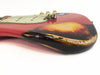 Close-up of vintage red and sunburst electric guitar body with worn and aged finish showing relic details and scratches on white background
