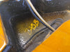Close-up of inside electric guitar cavity showing wiring and handwritten yellow markings on black painted surface