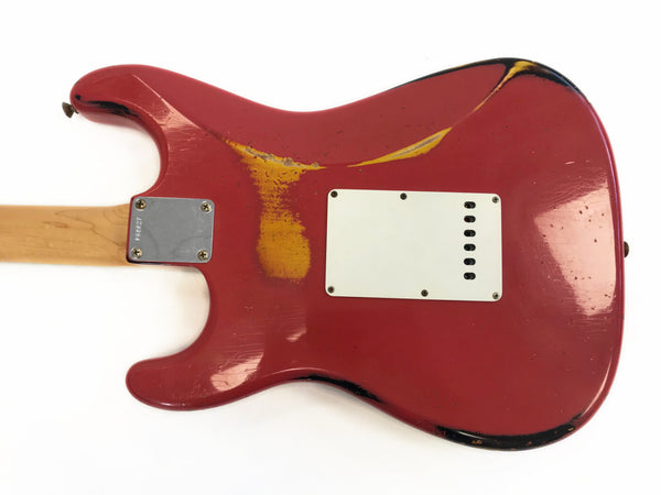 Vintage red electric guitar body with worn finish and white backplate showing aging and paint wear around edges, maple neck visible