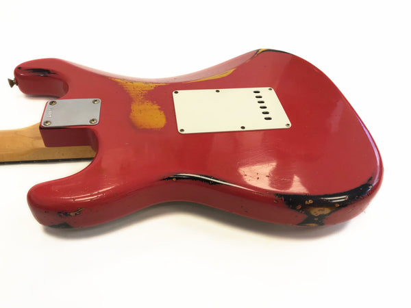 Red electric guitar body with visible wear and relic finish, showing back plate and neck joint, vintage style stratocaster design