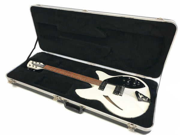 White Rickenbacker electric guitar with black pickguard and rosewood fretboard in black plush-lined hardshell guitar case