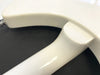 Close-up of white electric guitar neck joint and body heel on a black surface, showing smooth glossy finish