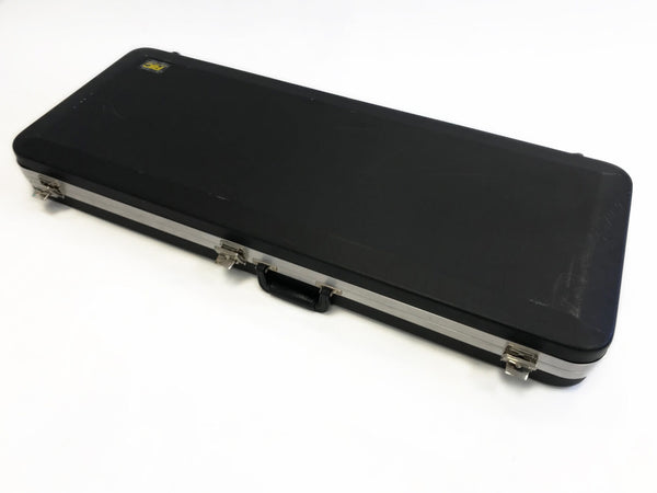 Black rectangular hard shell guitar case with metal latches and handle on white background