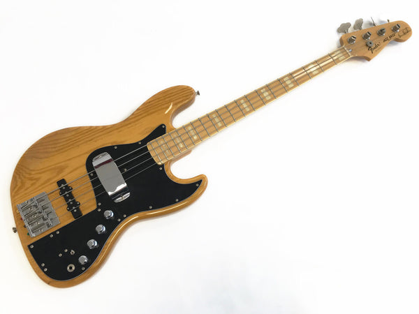 Fender Jazz Bass guitar with natural wood finish, maple neck, black pickguard, and chrome hardware on white background