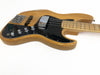 Natural wood finish electric bass guitar with black pickguard and chrome control knobs on white background
