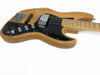 Natural wood finish electric bass guitar with black pickguard, chrome bridge, and control knobs on white background
