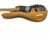Natural wood finish electric bass guitar with black pickguard and chrome hardware on white background
