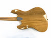 Back of polished natural wood electric guitar body with metal neck plate and maple neck with walnut stripe on white background
