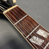 Close-up of rosewood guitar fretboard with mother of pearl block inlays and metal frets on Coffee House Guitars acoustic guitar