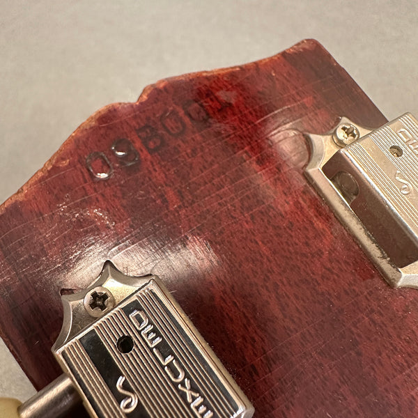 Close-up of vintage sunburst guitar headstock with two vintage Waverly Deluxe tuners and worn serial number stamp.