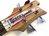 Close-up of Greco guitar headstock with tuning pegs and red-wrapped guitar strings on natural wood finish