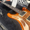 Close-up of Paul Reed Smith PRS electric guitar with flame maple top and bird inlays in a black plush guitar case at Coffee House Guitars.