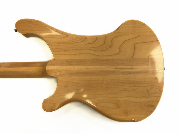 Back view of natural finished electric guitar body and neck showing wood grain and smooth contours on white background