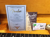 Fender 1960 Stratocaster Relic Certificate of Authenticity with Time Machine Series booklet and Fender guitar tag on orange guitar case background