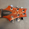 Paul Reed Smith Custom electric guitar headstock with six tuning pegs and wooden finish on grey background