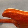 Close-up of glossy mahogany guitar body showing wood grain and smooth finish