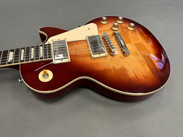 Sunburst electric guitar with dual humbucker pickups and cream pickguard on gray background, Coffee House Guitars product listing.