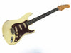 Vintage Fender Stratocaster electric guitar in aged white finish with tortoise pickguard and maple neck with rosewood fretboard, showing wear and relic details