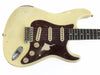 Vintage white electric guitar with tortoiseshell pickguard and single-coil pickups showing worn finish and aged hardware