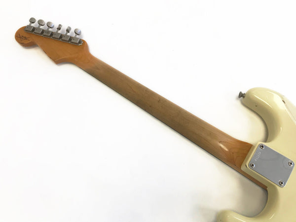 Back of cream electric guitar neck and headstock with six tuning pegs on white background, showing neck plate and strap button